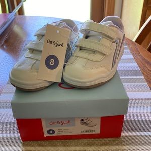 Cat & Jack White leather upper with two Velcro straps. Light lilac color inside